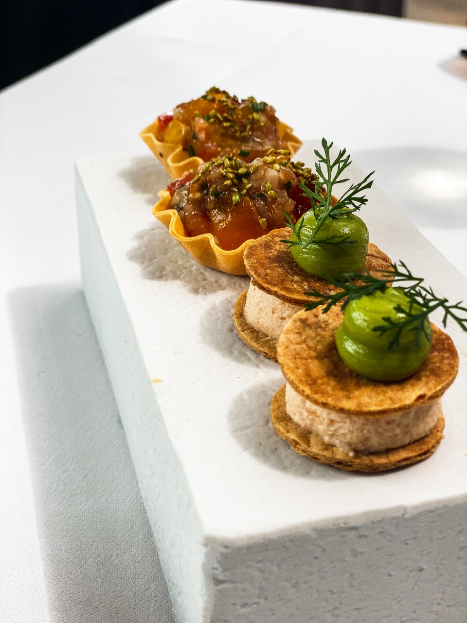 A beautiful presentation of refined appetizers on an elegant platter at De Bakermat restaurant, with each bite carefully prepared to offer a burst of flavor and texture.