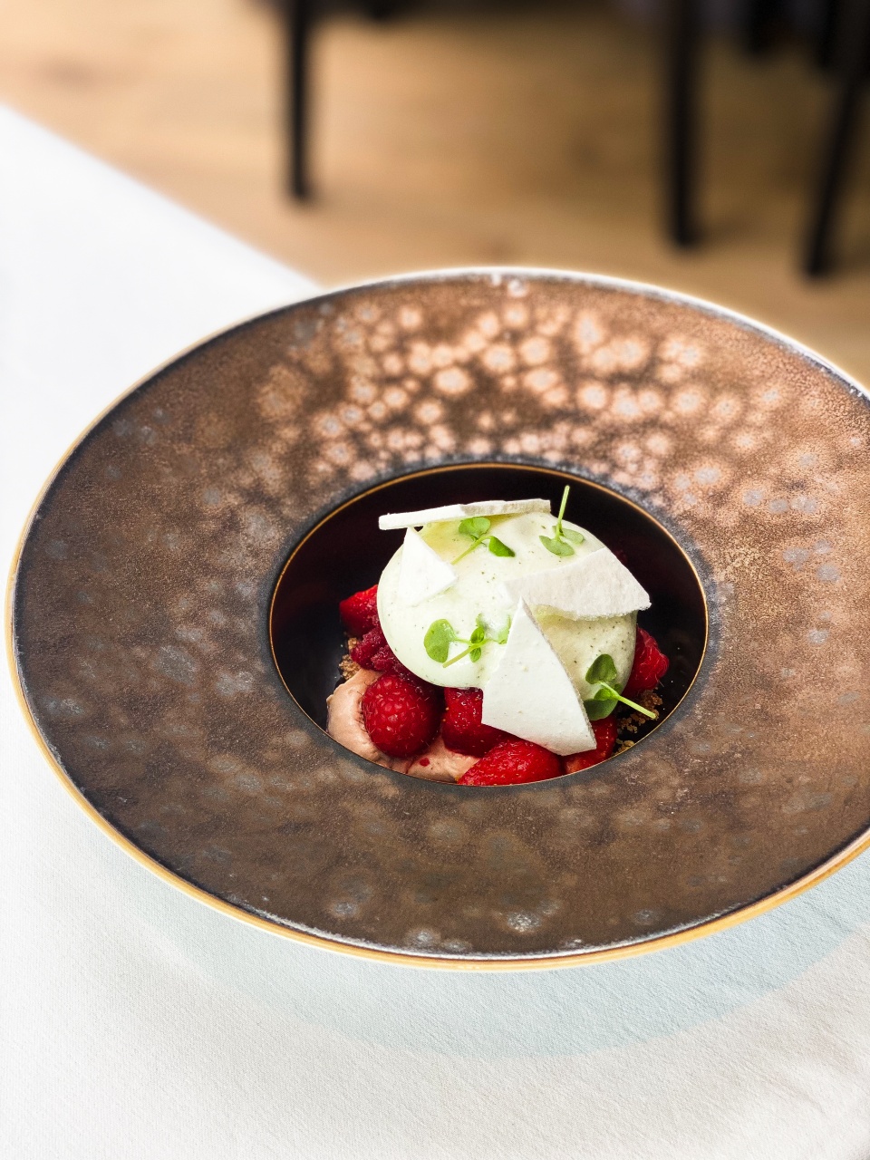 A subtly composed dessert of cremeaux of Verveine, espuma yogurt and meringe Italienne, beautifully presented with an artistic flair at restaurant De Bakermat.