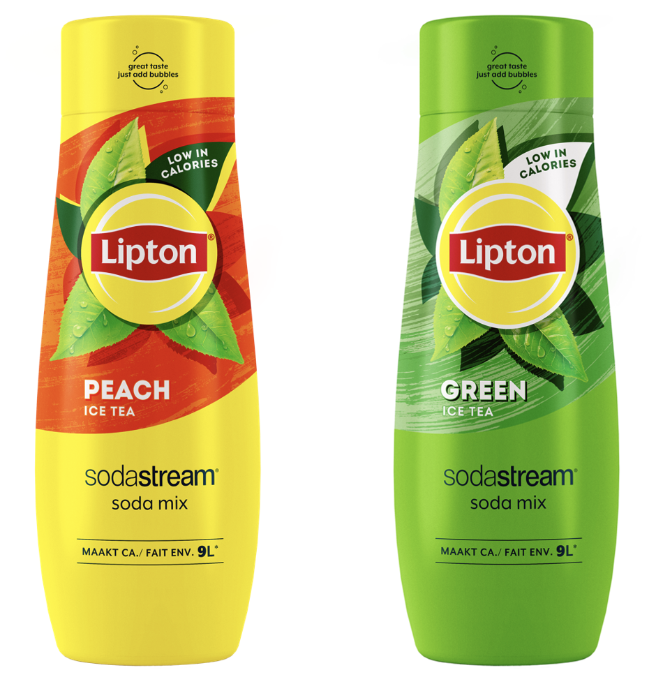 Two recycled plastic bottles (rPET) of SodaStream's new Lipton Ice Tea flavors - Green and Peach - stand side by side on a countertop, with a SodaStream appliance in the background. The green and peach colored labels stand out, making them appear inviting and ready to use, embodying the freshness and refreshment of summer fizzy drinks.
