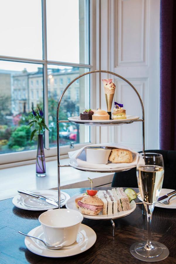 Image of a gourmet breakfast at the Kimpton Blythswood Square Hotel, showcasing a diverse selection of freshly prepared pastries, fruits, and Scottish delicacies, elegantly presented on a well-laid table.