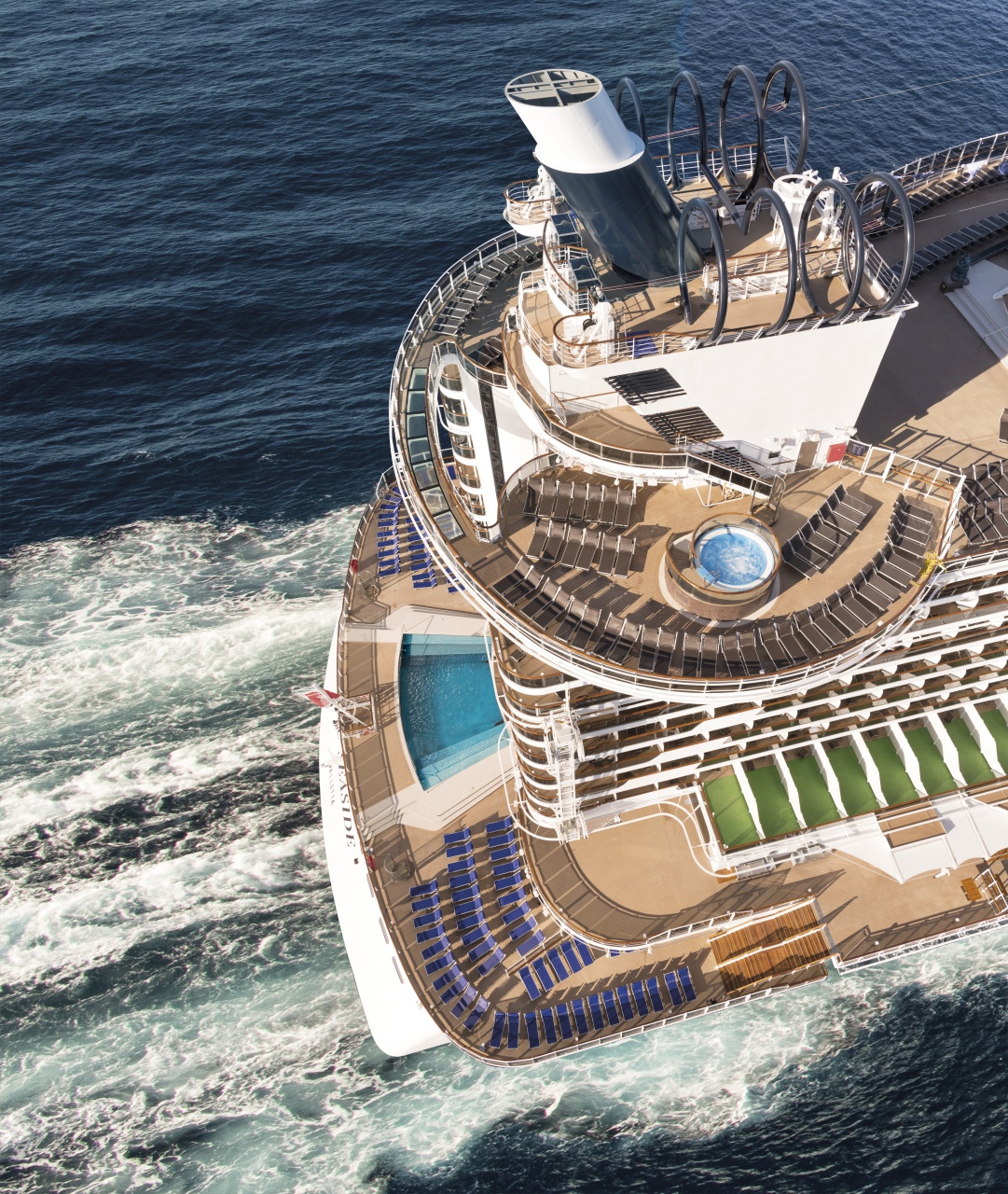 Rear deck of MSC Seaside cruise ship with sparkling pool and panoramic ocean views, inviting relaxation and luxury
